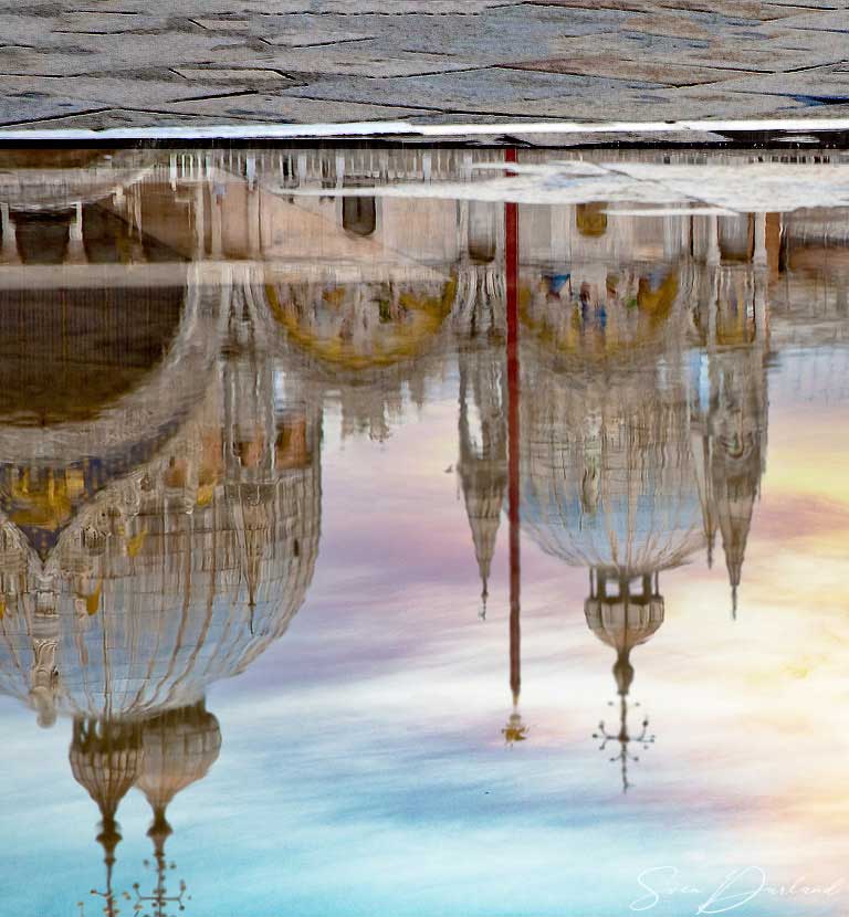 Basilica reflections in puddle on St Mark's Square
